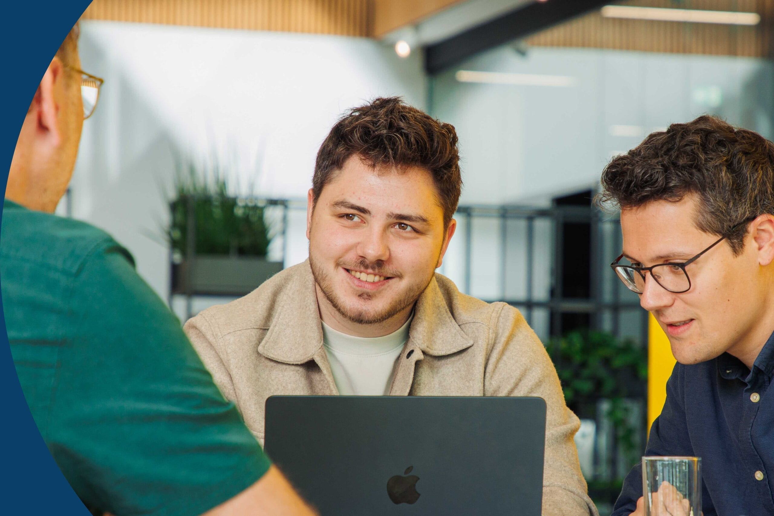 Three people discussing over a laptop e-commerce solutions